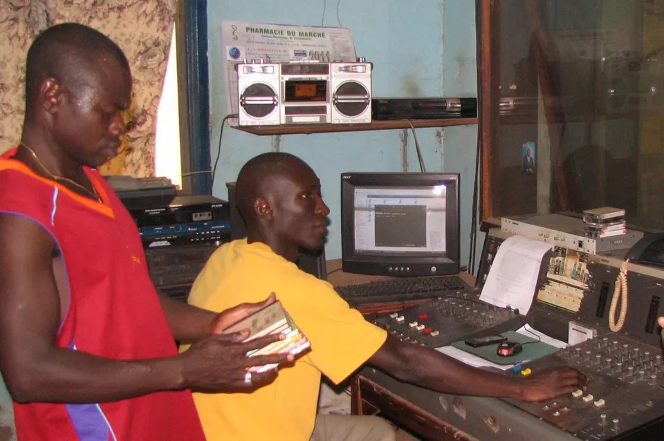Zambian men work in a recording studio