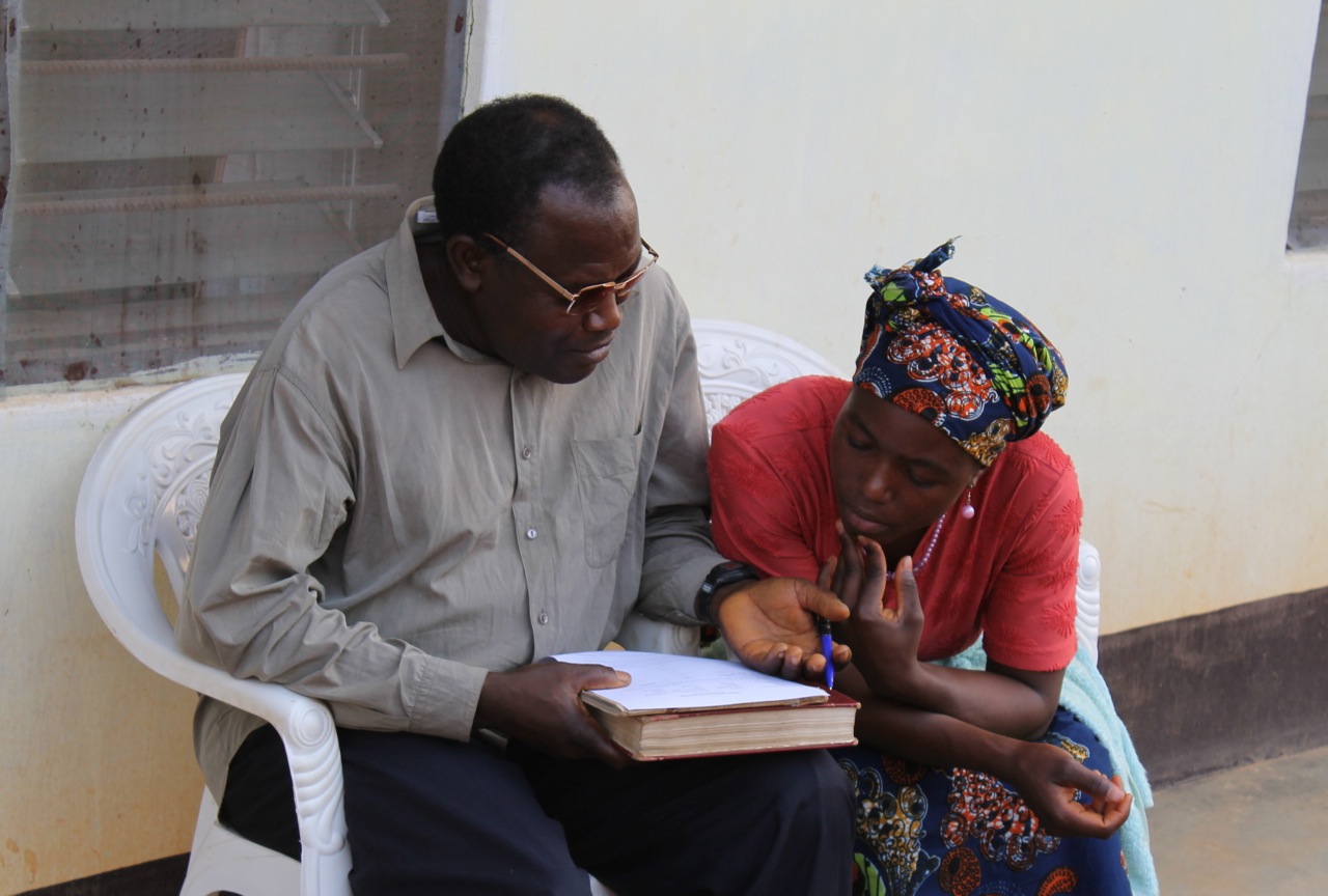 A man and woman in Africa read God's Word together