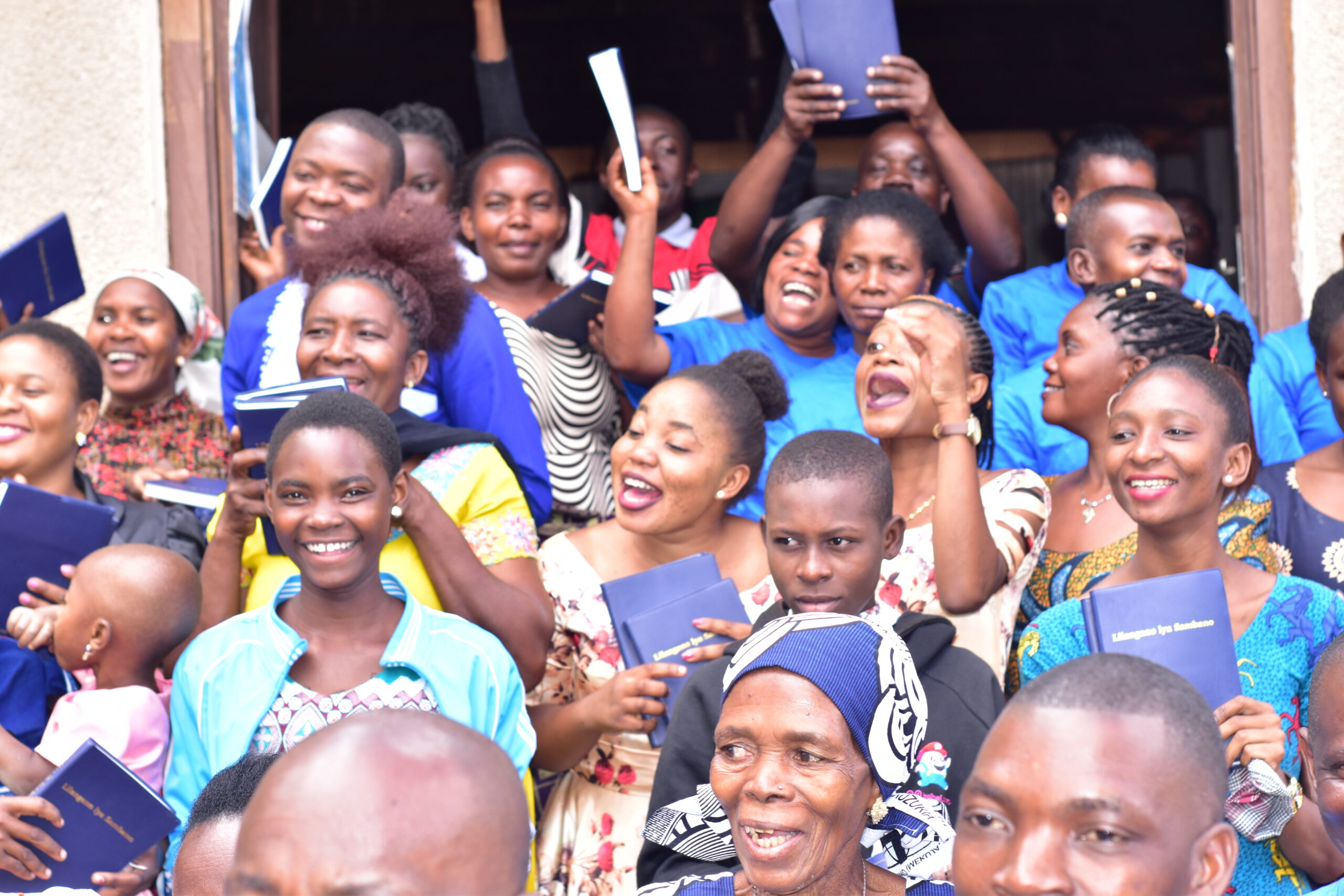A crowd in Tanzania rejoices with the Bible in their hands