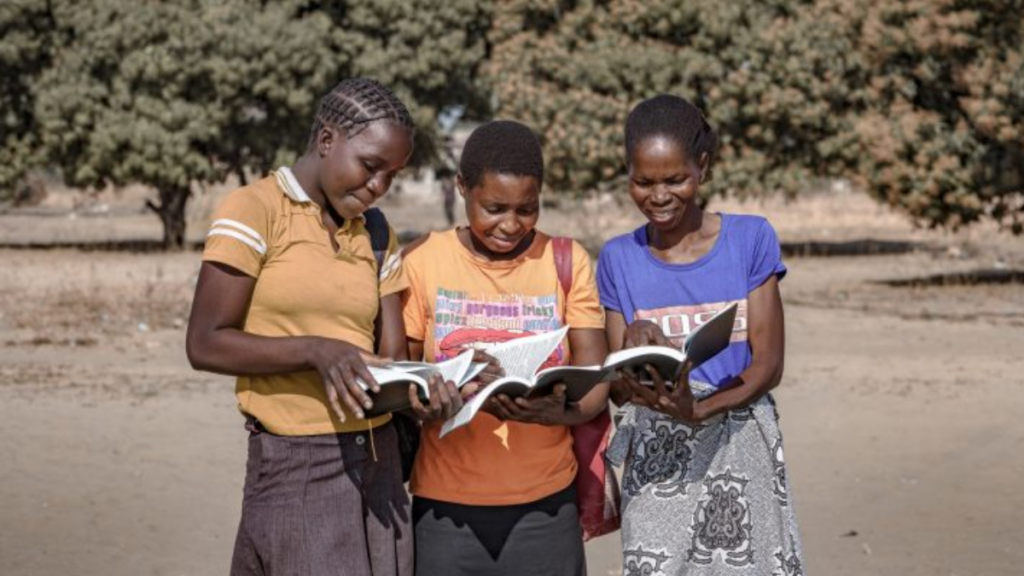 3 women each holding and looking at a Bible